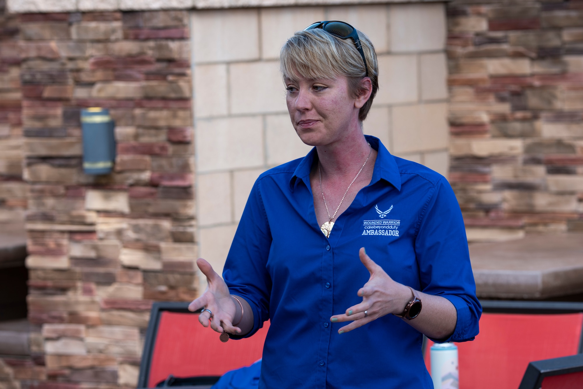 A woman in a blue shirt expresses herself.