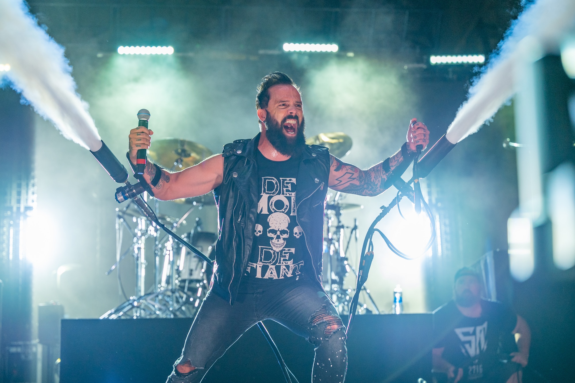 John Cooper, lead vocalist for the rock band Skillet, sets off the fog machines attached to his arms at Rock Fest Aug. 20, 2022, at Malmstrom Air Force Base, Mont.