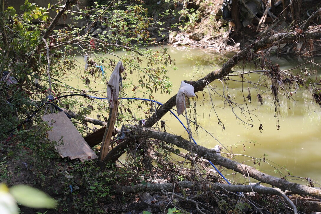 Personal belongings and trash line Troublesome Creek Aug. 19, 2022 in the aftermath of the flooding that happened last month. (U.S. Army National Guard photo by Sgt. 1st Class Benjamin Crane)