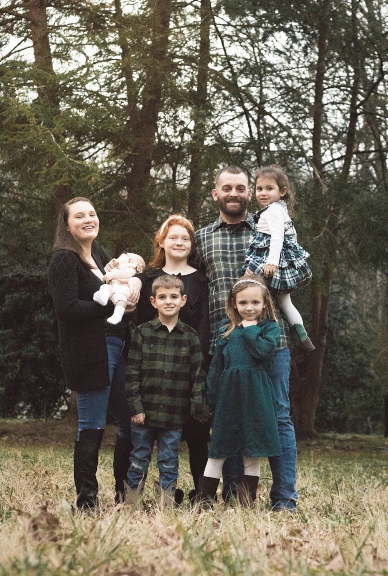 Army Sgt. Kathleen Thomassy-Mills poses with her family. Their home was destroyed in the flooding in Eastern Kentucky July 28, 2022.  (