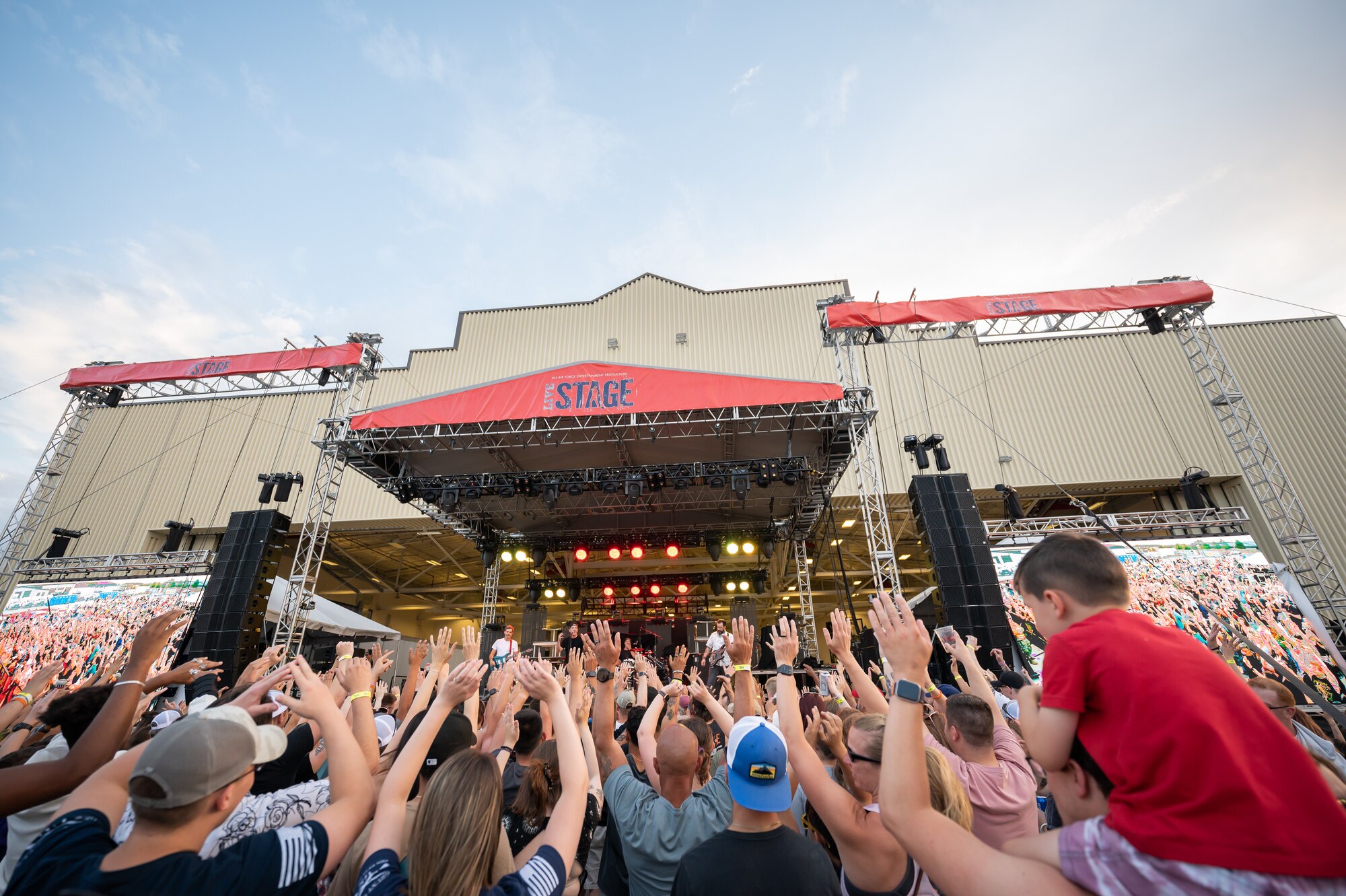 Audience members put their hands in the air during a song played by the rock band Hoobastank at Rock Fest Aug. 20, 2022, at Malmstrom Air Force Base, Mont.