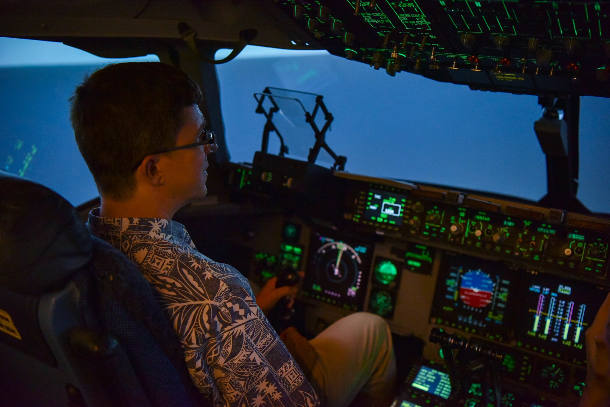 Timothy Nelson, Chief of Staff for U.S. Rep. Ed Case, pilots the C-17 Simulator during a staff delegation visit at Joint Base Pearl Harbor-Hickam, Hawaii, Aug. 23, 2022. The members visited with Airmen from the 15th Wing and were able to operate the C-17 Globemaster III simulator. (U. S. Air Force photo by Senior Airman Makensie Cooper)