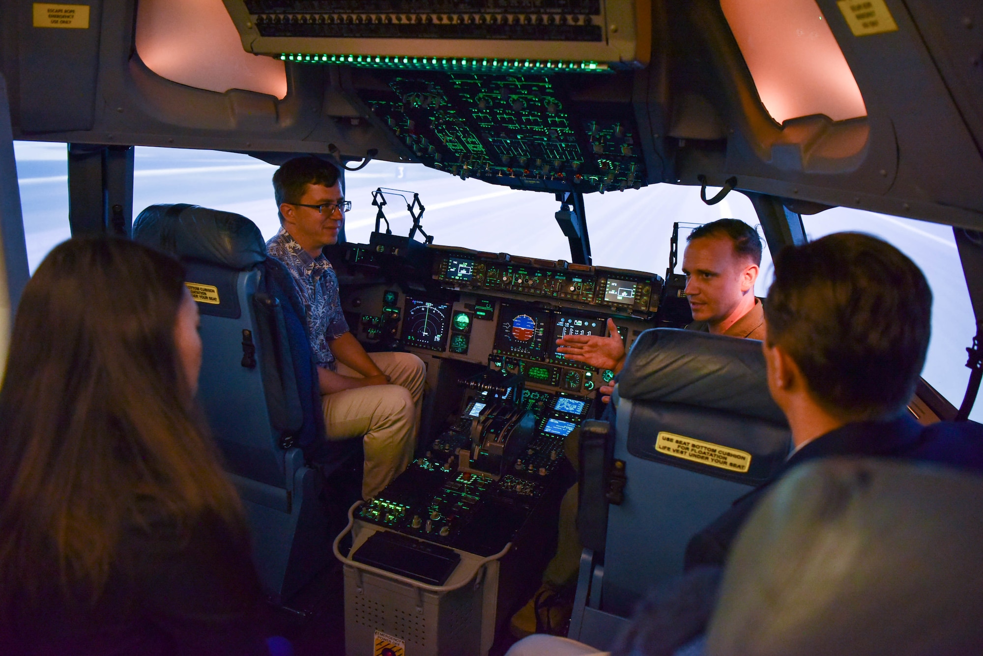U.S. staff delegation members of the House Appropriations Committee tour and operate the C-17 Simulator during a base visit at Joint Base Pearl Harbor-Hickam, Hawaii, Aug. 23, 2022. The purpose of the visit was to see how the 15th Wing and Hawaii Air National Guard utilize Total Force Integration to accomplish the mission of ensuring a free and open Indo-Pacific. (U.S. Air Force photo by Senior Airman Makensie Cooper)