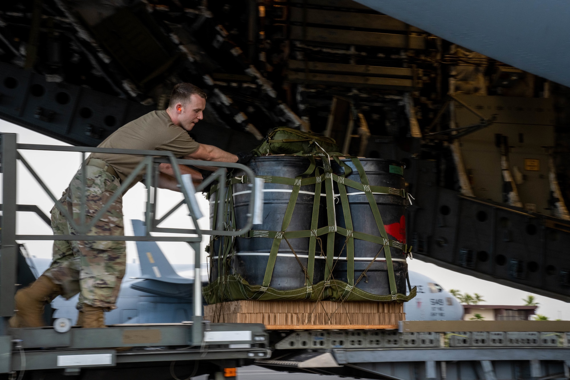 Staff Sgt. Waite Rowland, 647th Logistics Readiness Squadron combat mobility flight supervisor, loads cargo onto a C-17 Globemaster III in support of an exercise at Joint Base Pearl Harbor-Hickam, Hawaii, Aug. 24, 2022. The 647th LRS is responsible for ensuring passengers and cargo are loaded onto the aircraft safely and efficiently in support of 15th Wing airlift operations. (U.S. Air Force photo by Senior Airman Makensie Cooper)