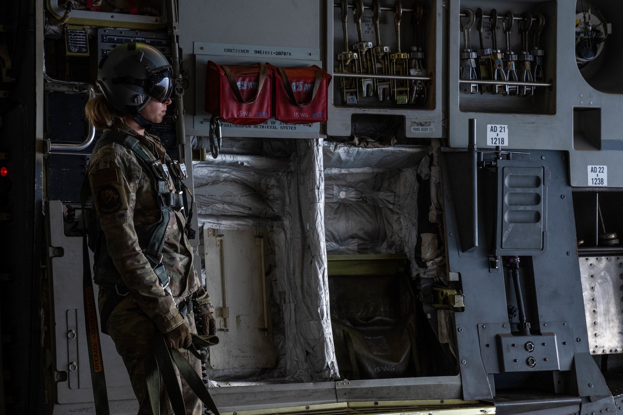 Staff Sgt. Georgeann Heck, 535th Airlift Squadron loadmaster, waits for the signal to release container delivery system bundles from a C-17 Globemaster III during an exercise around the Hawaiian Islands Aug. 24, 2022. Aircrew from the 535th Airlift squadron conducted training by performing an airdrop at Kane’s Drop Zone. (U.S. Air Force photo by Senior Airman Makensie Cooper)