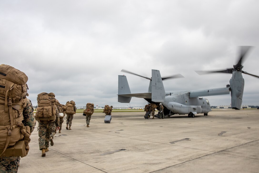 U.S. Marines with the Forward Command Element, 26th Marine Expeditionary Unit, board an MV-22B Osprey assigned to Marine Medium Tiltrotor Squadron (VMM) 365, 2d Marine Aircraft Wing, during the Marine Expeditionary Unit Field Exercise (MEU FEX) at Marine Corps Air Station New River, North Carolina, Aug. 23, 2022. The MEU FEX demonstrates the MEU's ability to transition command and control from ship-to-shore through the echeloning of command capabilities and expeditionary logistics planning. (U.S. Marine Corps photo by Cpl. Eric Ramirez)