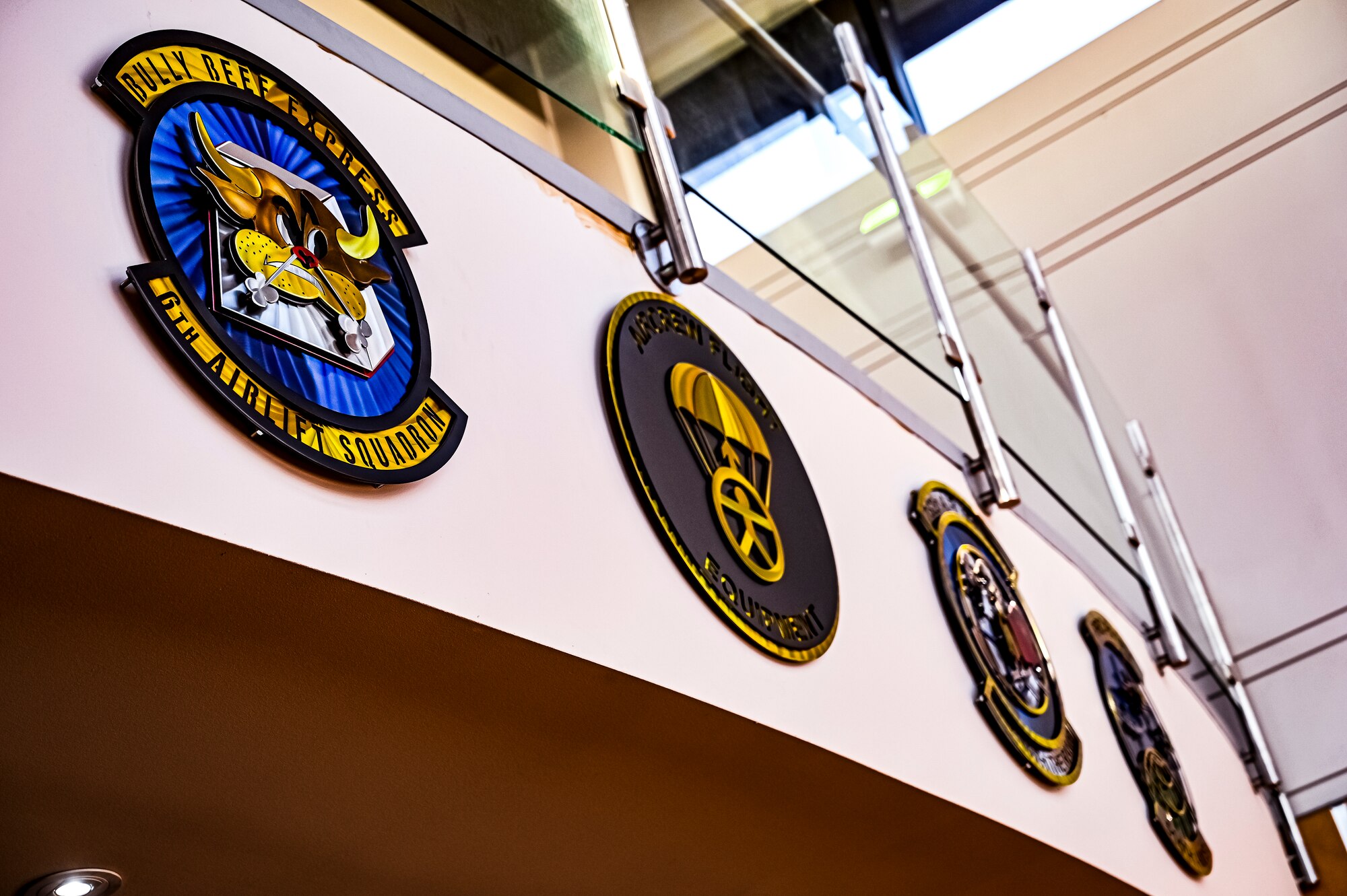 305th Air Mobility Wing Squadron emblems are displayed at the Consolidated Maintenance Operations Facility building prior to the arrival of U.S. Air Force Maj. Gen. Albert Miller, Aircrew Task Force director, at Joint Base McGuire-Dix-Lakehurst, N.J. on Aug. 25, 2022. Miller has amplified community outreach to aircrew members in the field through increased site visits. These visits provide a chance to have meaningful discussions with all aircrew members to capture operational, quality of life, and quality of service concerns to inform policy decisions.
