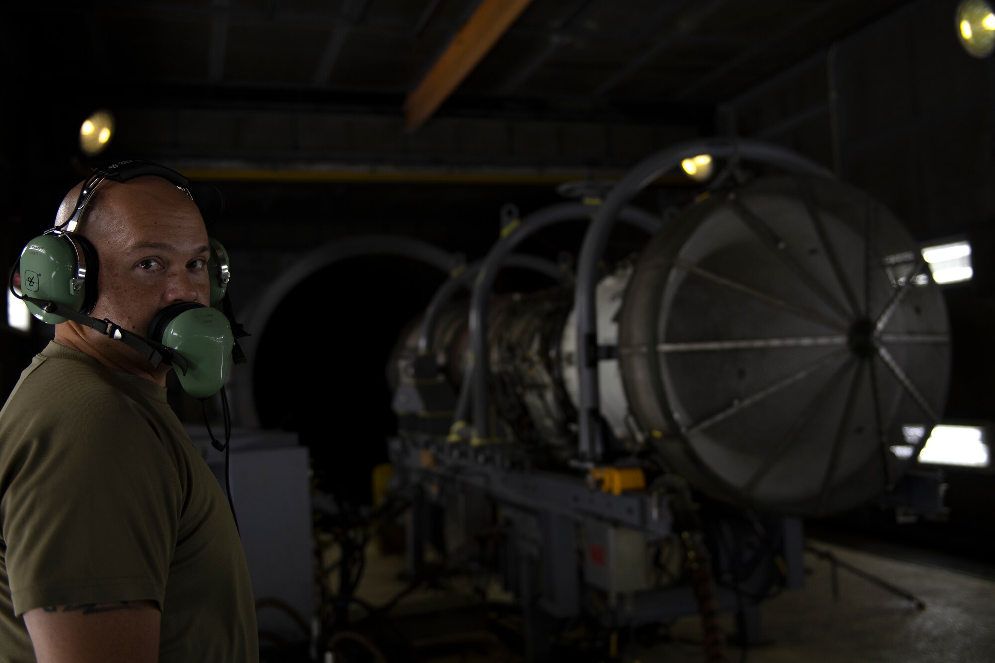 U.S. Air Force Staff Sgt. Wallace Winkler, 18th Component Maintenance Squadron test cell craftsman, prepares to conduct an engine run inside the test cell at Kadena Air Base, Japan, Aug. 25, 2022. The engine test cell enables maintenance personnel to safely test uninstalled aircraft engines under actual load conditions. (U.S. Air Force photo by Senior Airman Jessi Roth)