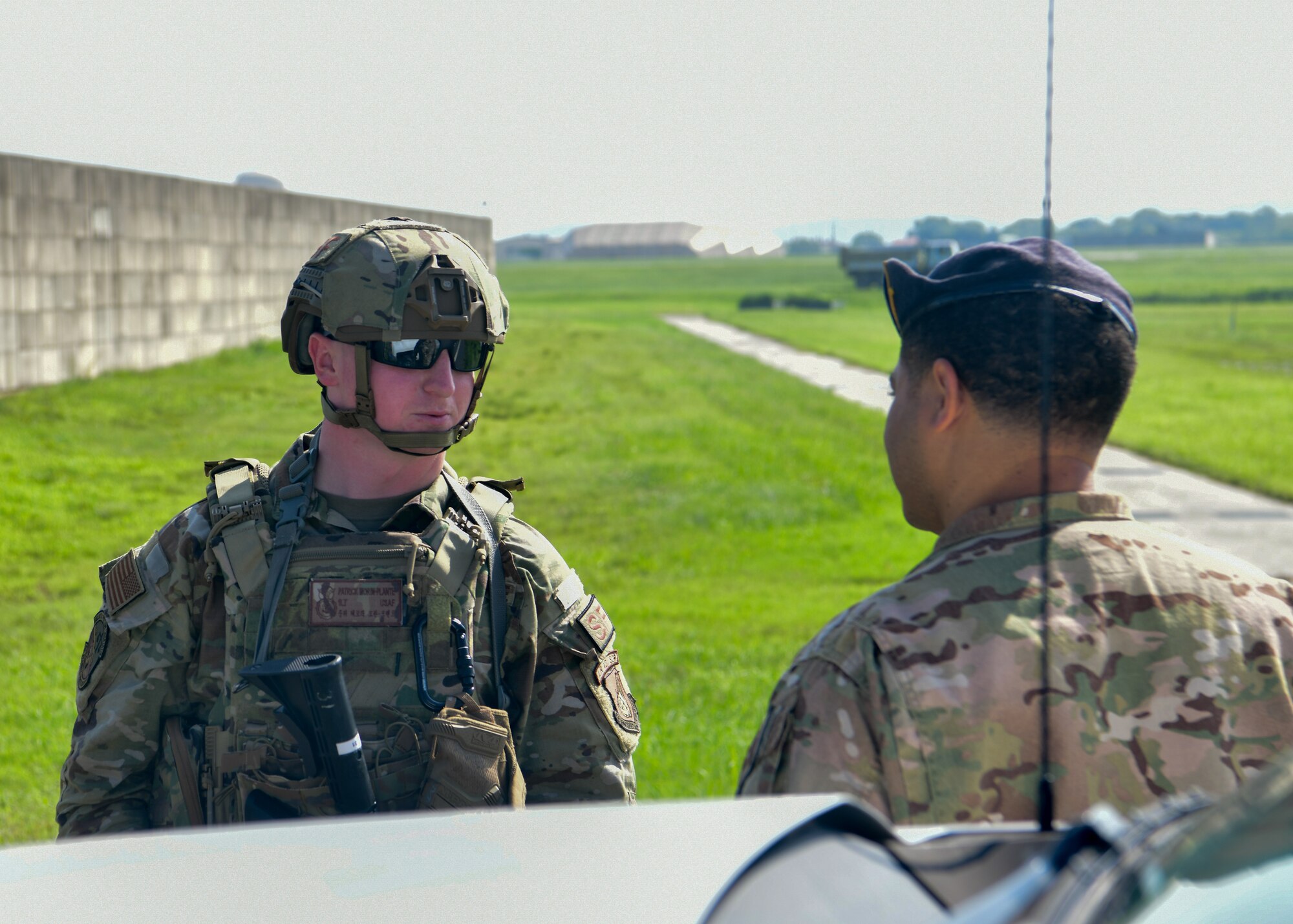 Military police officers talk to each other during a training event.