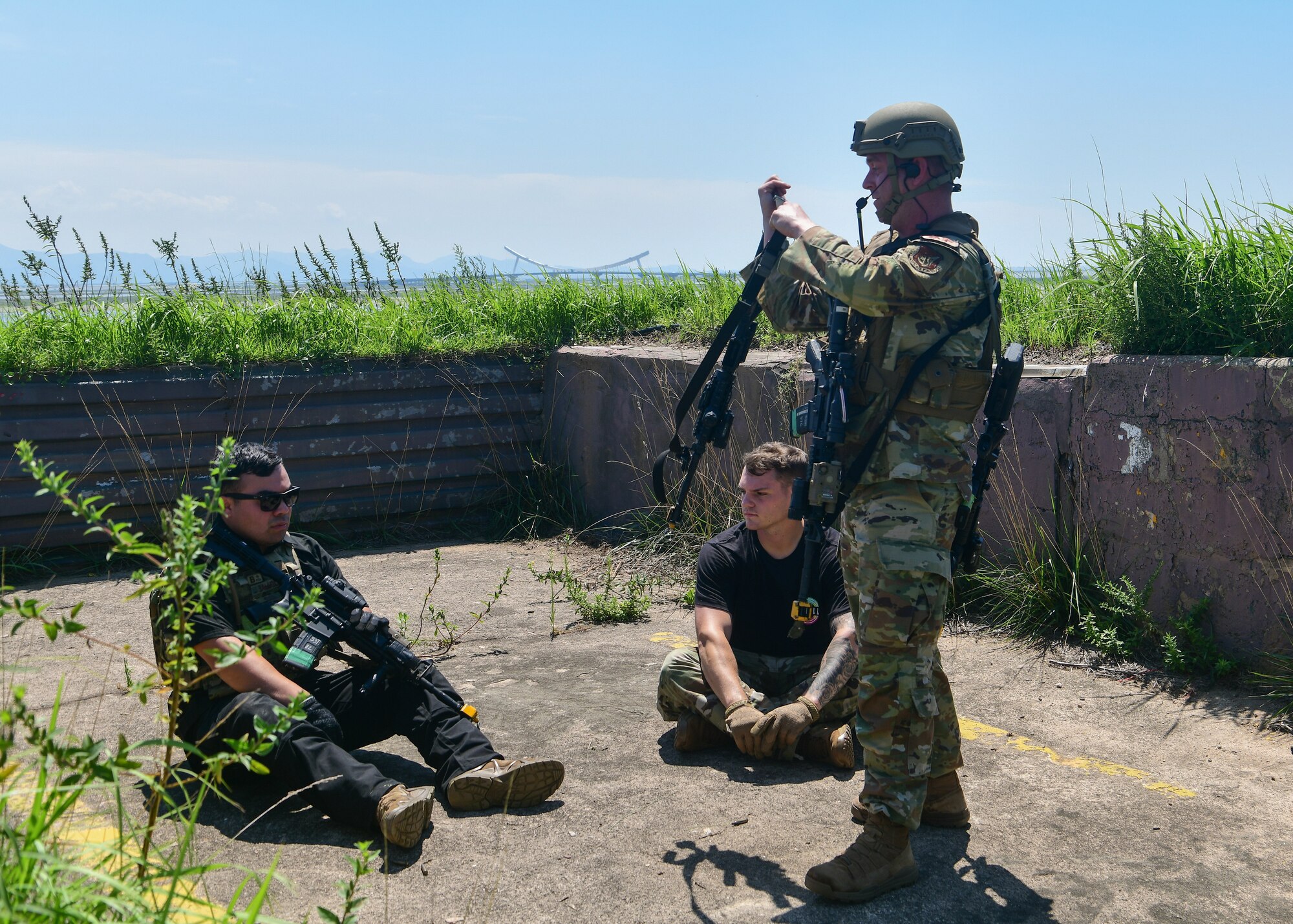 A military police officer apprehends fallen adversaries during training.
