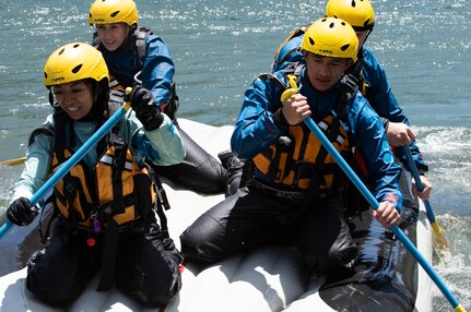 Hawaii, Nevada and California Air National Guard Airmen paddle a boat in rough water during Swift Water Rescue Training Jun. 8, 2022 on the Truckee River, Calif. The course focused on the fundamentals of survival in moving water, swift water swimming, shore, boat, and in-water rescue.