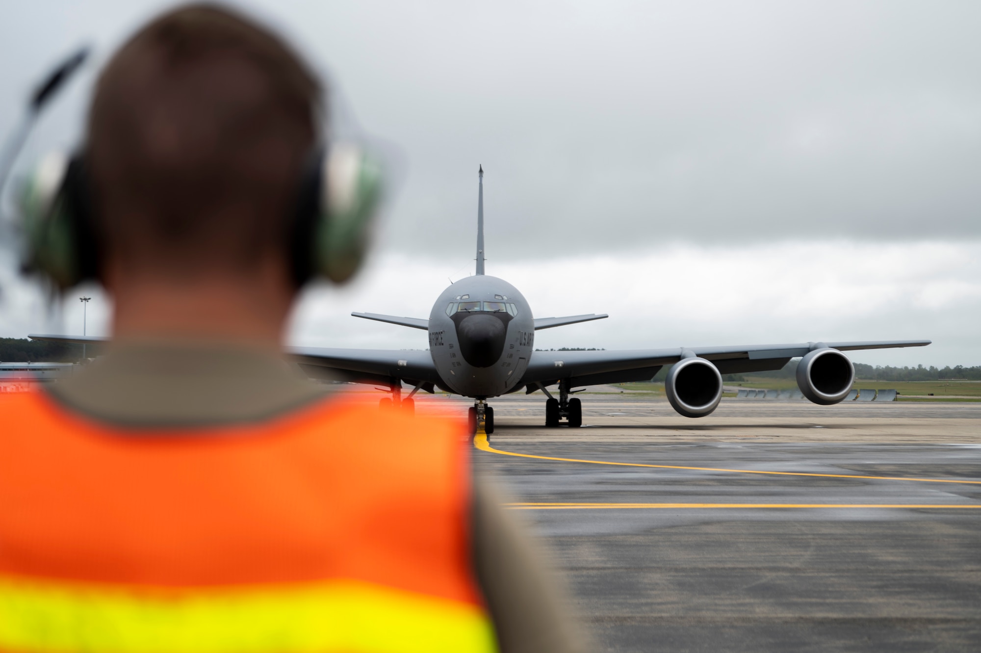 A 6th Aircraft Maintenance Squadron crew chief marshals a KC-135 Stratotanker assigned to the 91st Air Refueling Squadron before take off at Bangor Air National Guard Base, Maine, Aug. 23, 2022.