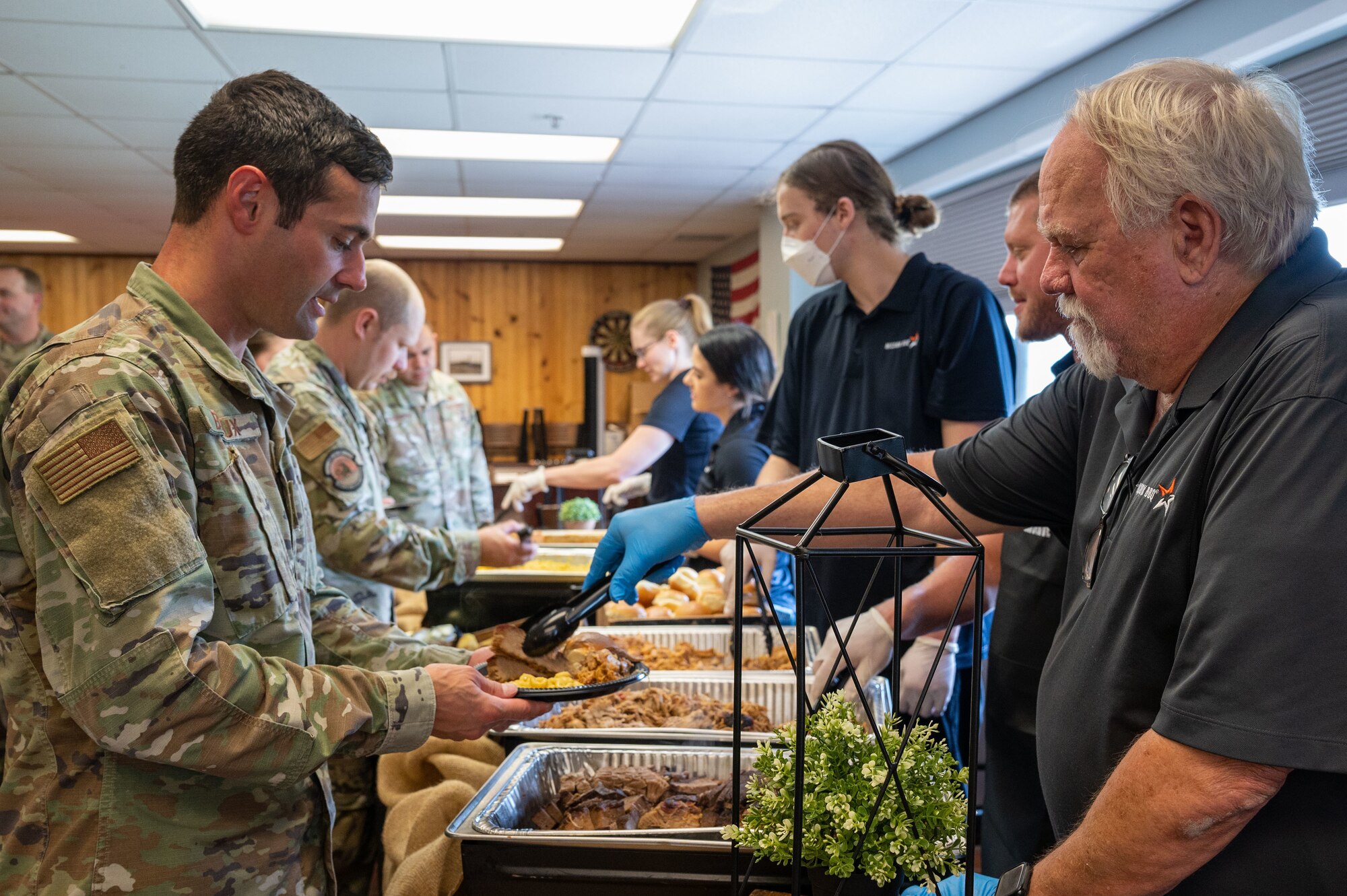 Master Sgt. Ryan Breaux, 436th Civil Engineer Squadron unaccompanied housing superintendent, receives food at the Meet, Greet, Eat with Chef Robert Irvine event on Dover Air Force Base, Delaware, Aug. 25, 2022. More than 75 Airmen attended the event which included a photo opportunity with Irvine and a catered lunch. (U.S. Air Force photo by Senior Airman Cydney Lee)