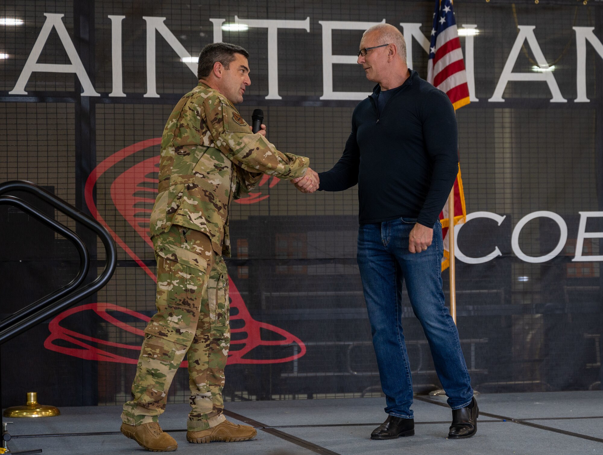 Col. Rusty Gohn, left, 436th Airlift Wing vice commander, shakes hands with Robert Irvine during the Meet, Greet, Eat with Chef Robert Irvine event on Dover Air Force Base, Delaware, Aug. 25, 2022. More than 75 Airmen attended the event which included a photo opportunity with Irvine and a catered lunch. (U.S. Air Force photo by Senior Airman Cydney Lee)