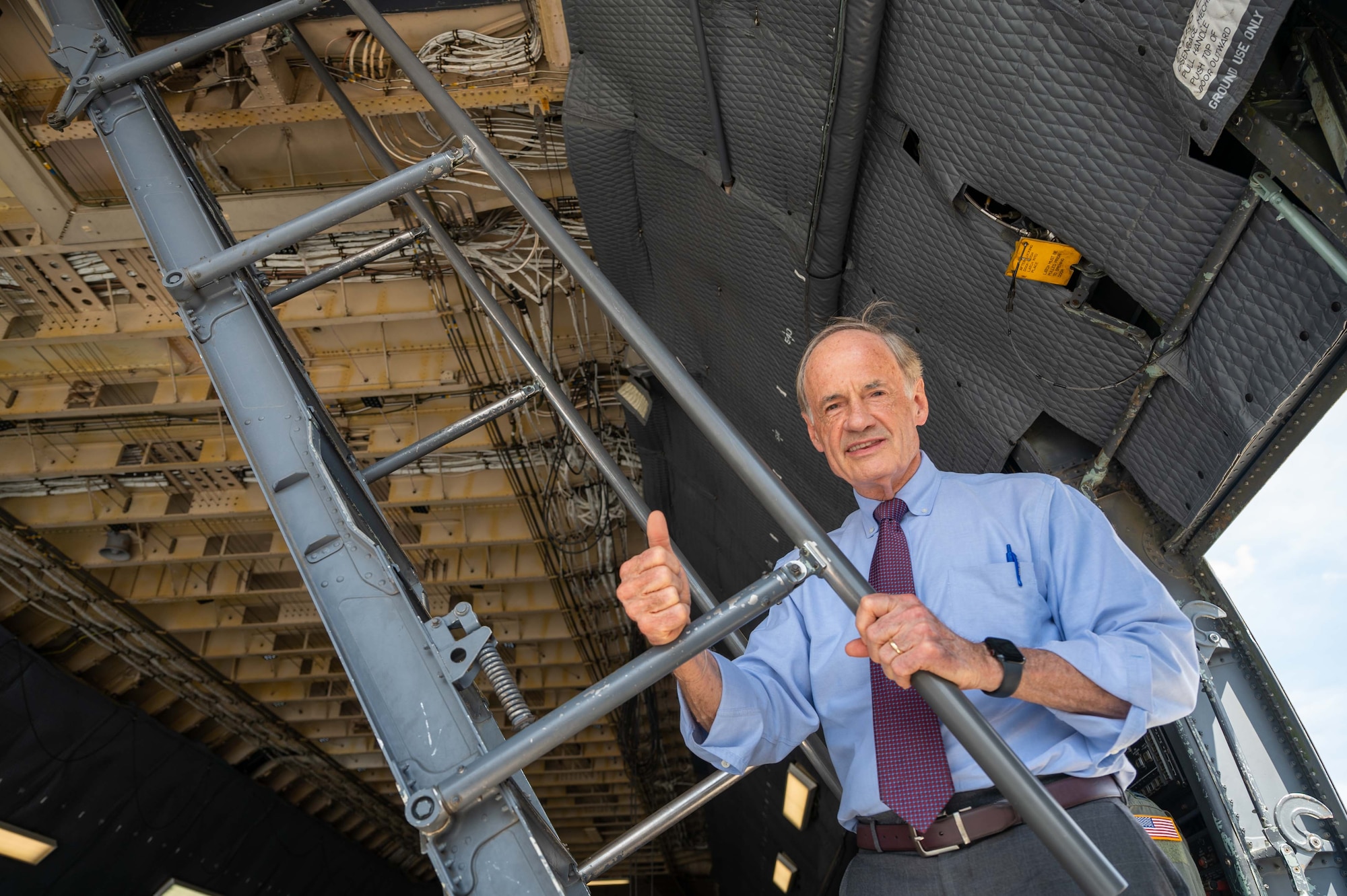 Sen. Tom Carper poses for a photo on the crew steps of a C-5M Super Galaxy at Dover Air Force Base, Delaware, Aug. 25, 2022. Throughout his visit, Carper discussed the Airmen’s role in security assistance missions in support of U.S. partners and allies. (U.S. Air Force photo by Senior Airman Faith Barron)