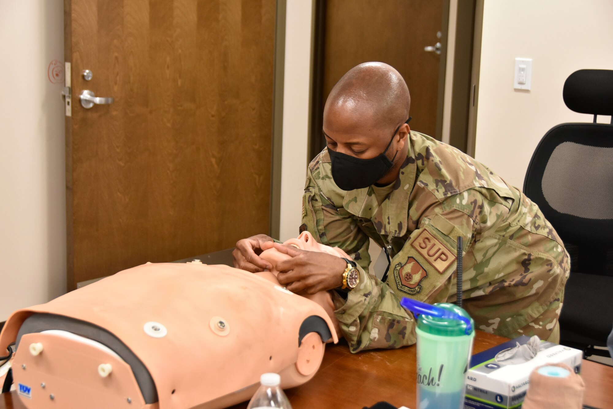 Master Sgt. Don Wilson practices the jaw thrust technique for opening a victim’s airway during Tactical Combat Casualty Care training Aug. 15, 2022, at the Medical Aid Station, Arnold Air Force Base, Tennessee. TCCC trainees are taught lifesaving techniques, strategies and procedures, allowing those who have been trained to provide best practice trauma care both on and off the battlefield. Wilson was part of the first TCCC class at Arnold. The first level of TCCC training is required by all Department of Defense service members by April 2023. (U.S. Air Force photo by Bradley Hicks) (This image was altered by obscuring a badge for security purposes)
