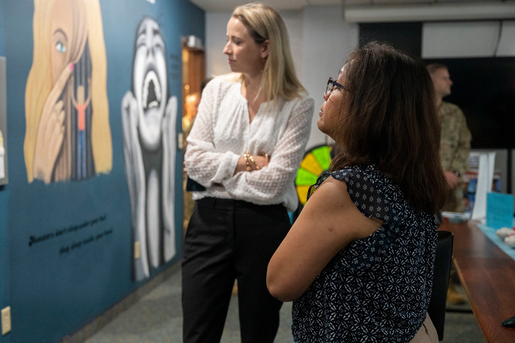 A woman observes a mural