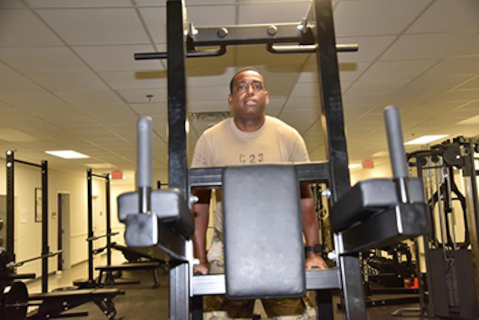 U. S. Army Sgt. Joshua Holloway, doing a pull-up exercise at the Fort Bragg, North Carolina, Soldier Recovery Unit Gym on July 14, 2022.