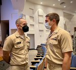 At the 2022 Annual Navy Bureau of Medicine and Surgery (BUMED) Operational Roadshow hosted at Navy Medicine Readiness and Training Command (NMRTC) San Diego, medical interns attended the presentation to help decide where to next take their Naval and medical careers, Aug. 25. Capt. Rhett Barrett, (L) Navy Bureau of Medicine and Surgery (BUMED) medical core career planner, and Lt. Aaron Wickard, (R) NMCSD general surgery intern, discuss post-internship operational career opportunities. NMCSD's mission is to prepare service members to deploy in support of operational forces, deliver high quality healthcare s
