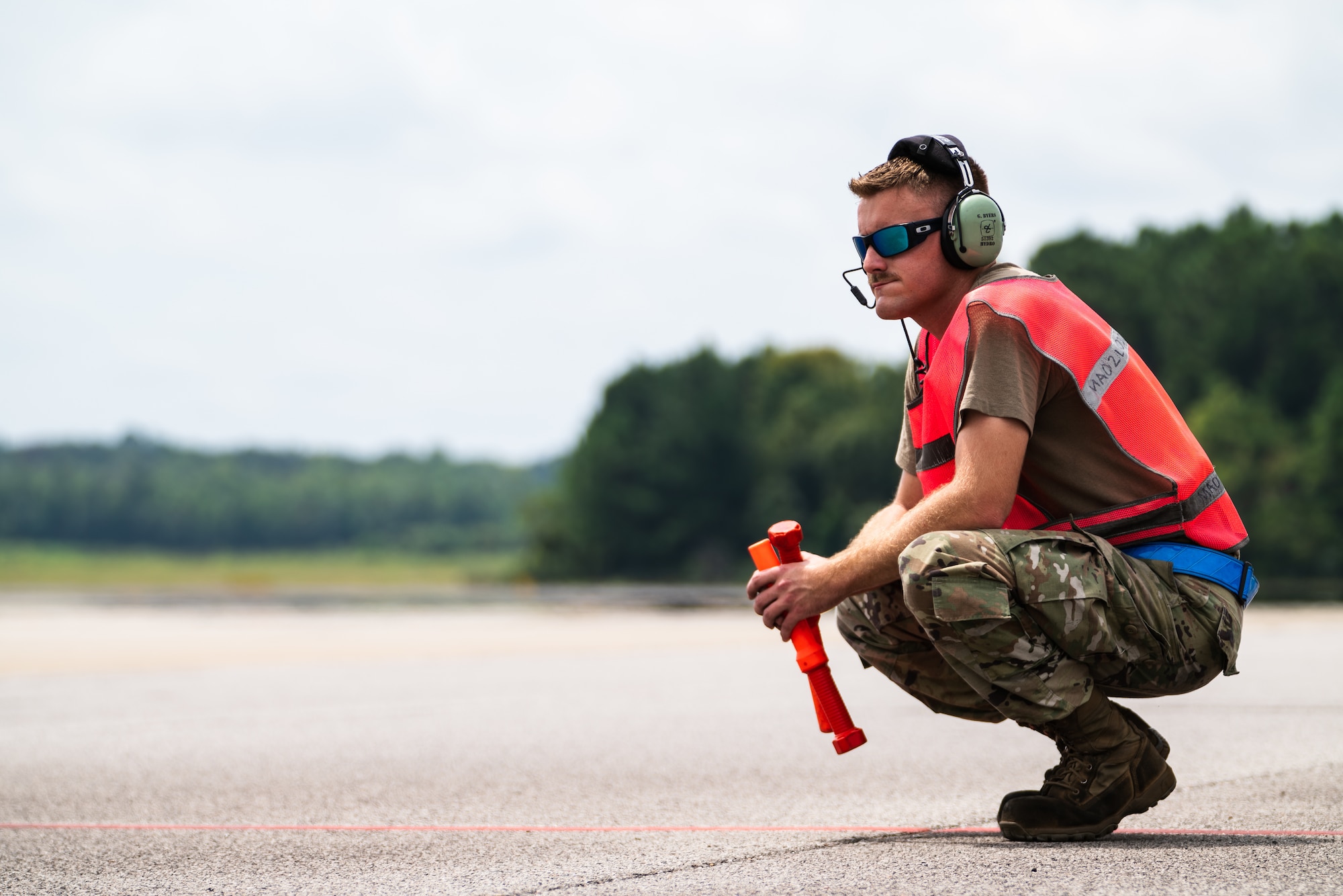 U.S. Air Force Staff Sgt. Garrett Byers, 6th Maintenance Squadron hydraulics specialist, prepares to marshal an aircraft during the 6th Air Refueling Wing Agile Combat Employment capstone exercise at Joint Base Charleston, South Caroline, Aug. 23, 2022.