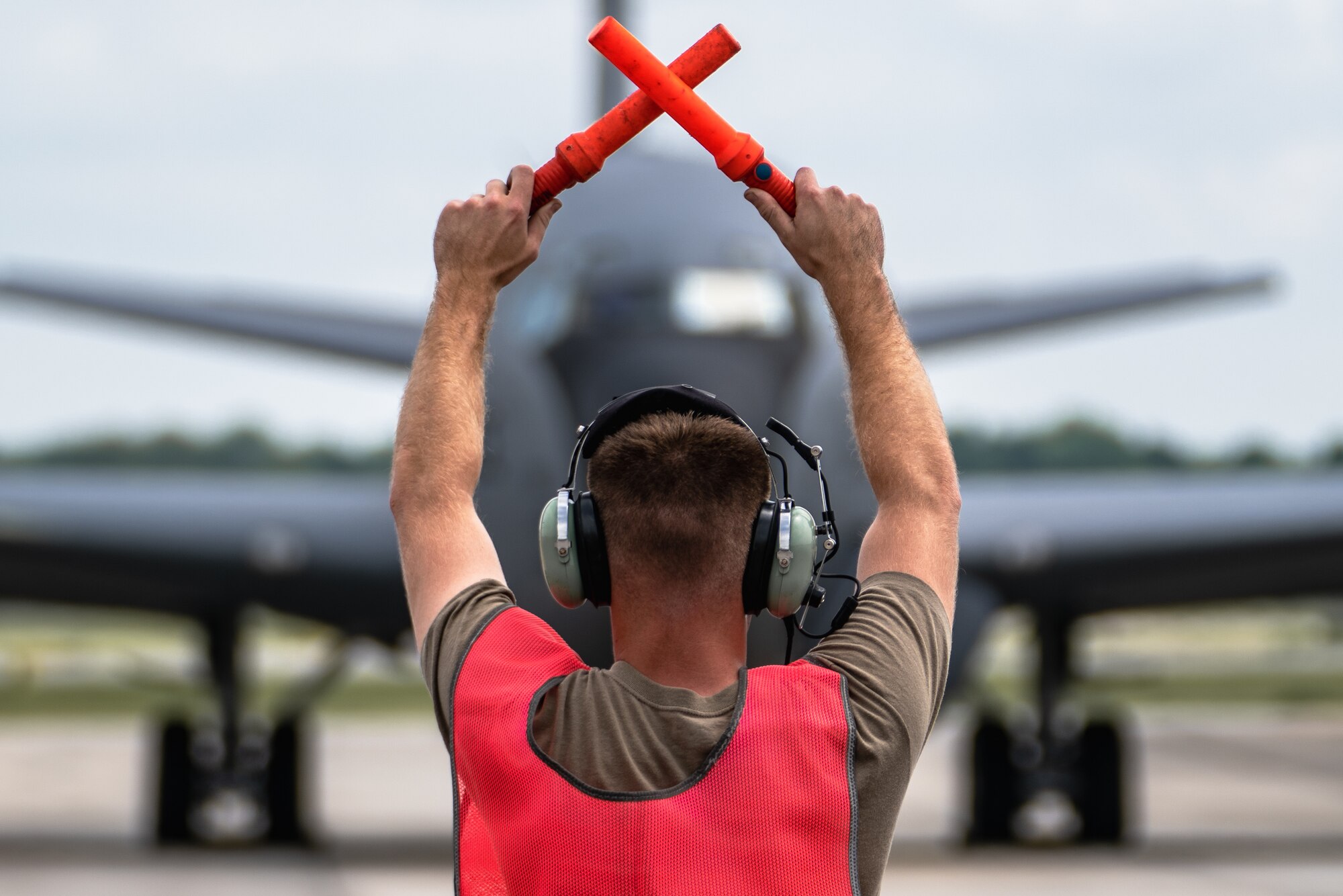 U.S. Air Force Staff Sgt. Garrett Byers, 6th Maintenance Squadron hydraulics specialist, marshals a KC-135 Stratotanker aircraft assigned to the 6th Air Refueling Wing during the Agile Combat Employment capstone exercise at Joint Base Charleston, South Carolina, Aug. 23, 2022.
