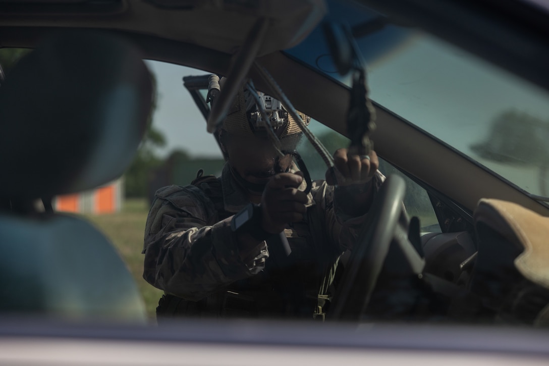 An explosive ordnance disposal technician with Marine Forces Special Operations Command attaches his equipment to the inside of the car during a training event June 17, 2022. The EOD primer tests all aspects of a technician’s knowledge and expertise needed to perform as the only tech on a Marine Special Operations Team while operating in austere, politically sensitive, or hostile environments. EOD technicians assigned to MARSOC have completed Marine Special Operations Forces Explosive Ordnance Disposal Level 1, which trains Fleet Marine Force EOD technicians in the knowledge and skills required to support the core tasks assigned to MARSOC as a special operations capability specialist. (U.S. Marine Corps photo by Sgt. Brennan Priest)