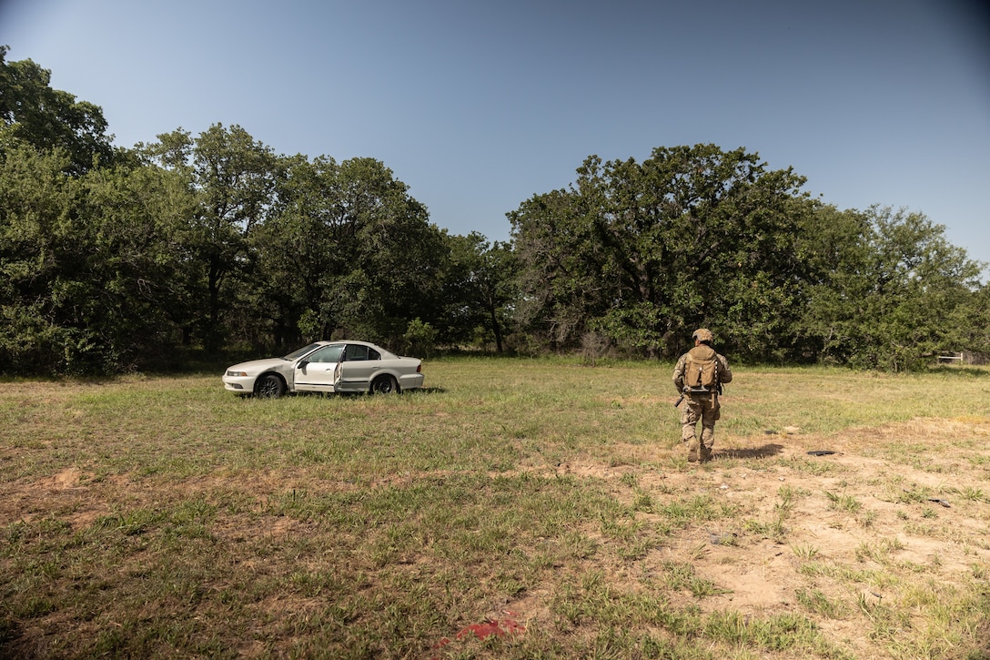 An explosive ordnance disposal technician with Marine Forces Special Operations Command approaches a vehicle during a training event June 17, 2022. The EOD primer tests all aspects of a technician’s knowledge and expertise needed to perform as the only tech on a Marine Special Operations Team while operating in austere, politically sensitive, or hostile environments. EOD technicians assigned to MARSOC have completed Marine Special Operations Forces Explosive Ordnance Disposal Level 1, which trains Fleet Marine Force EOD technicians in the knowledge and skills required to support the core tasks assigned to MARSOC as a special operations capability specialist. (U.S. Marine Corps photo by Sgt. Brennan Priest)