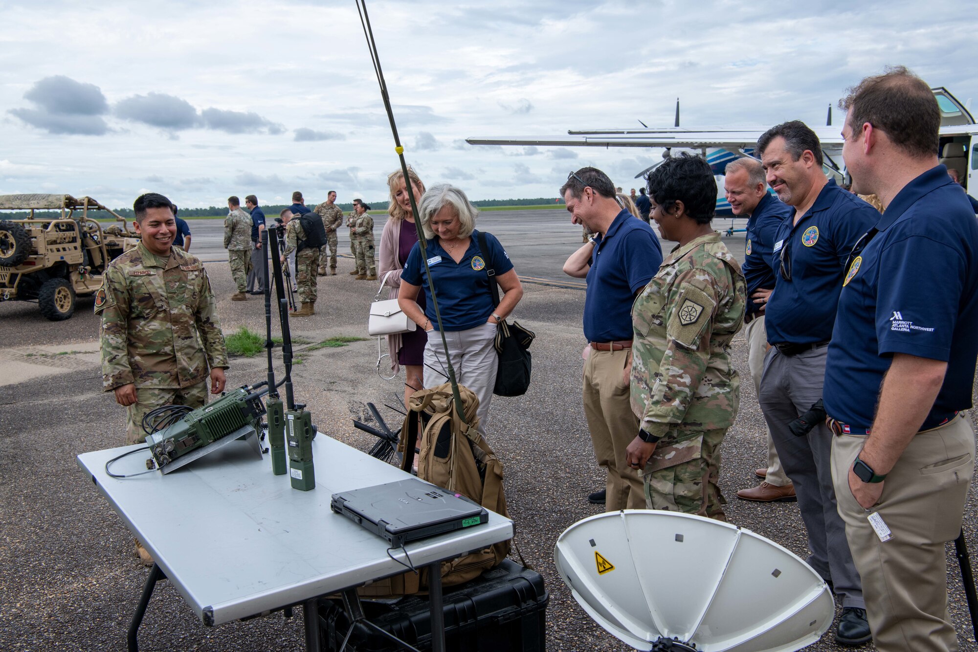 Civic leaders view a display of communications equipment.