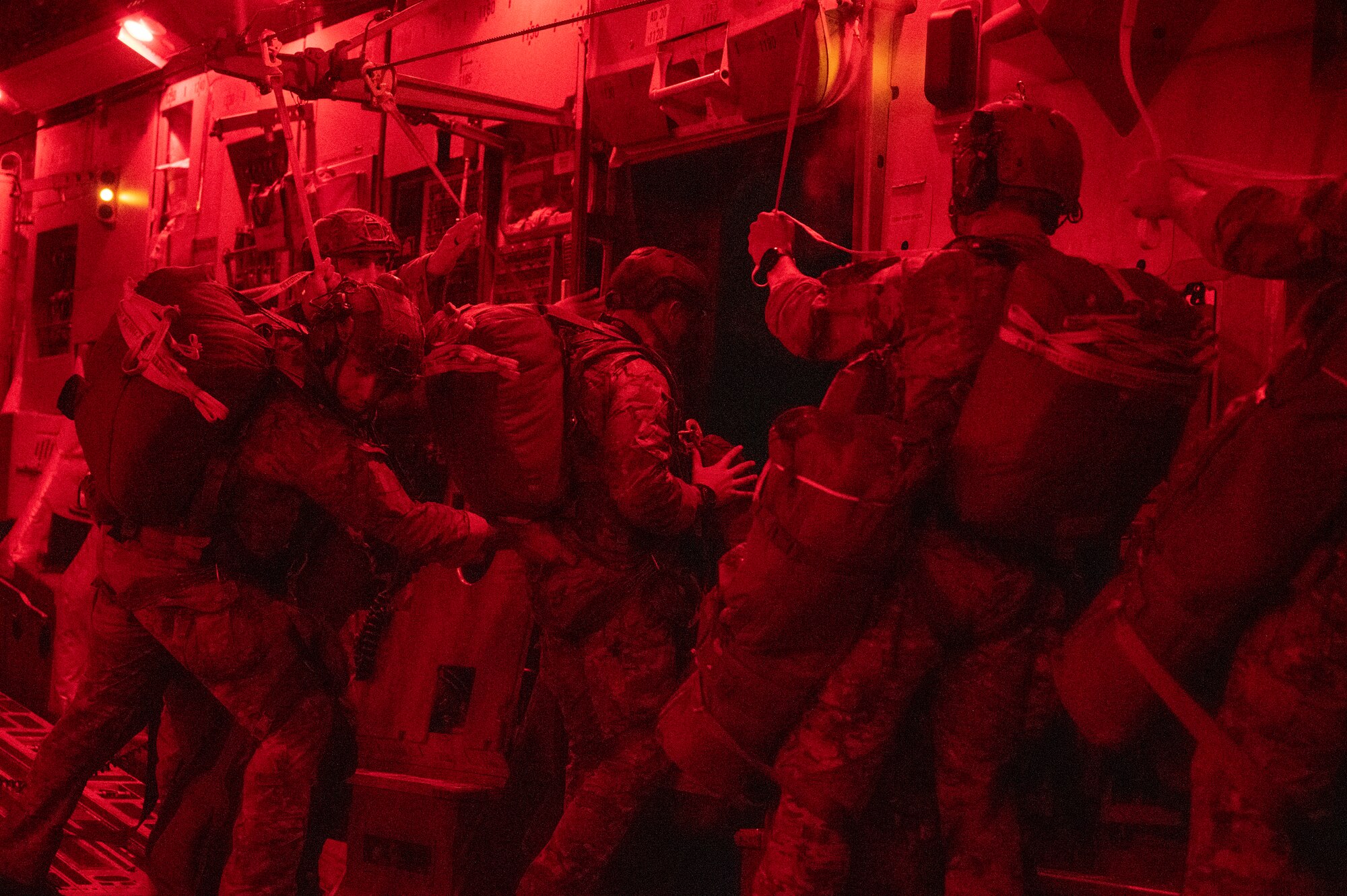 Army rangers prepare to jump out of a C-17.