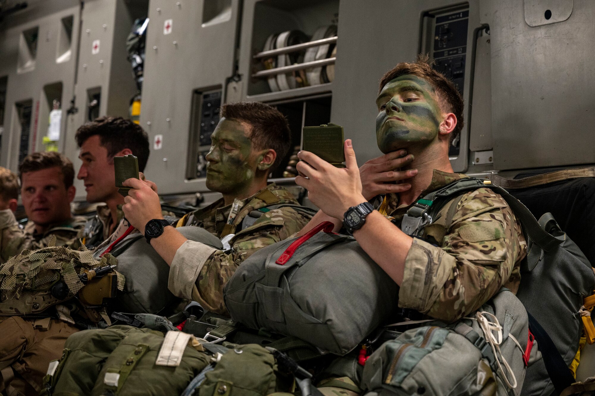 Army soldiers apply face paint