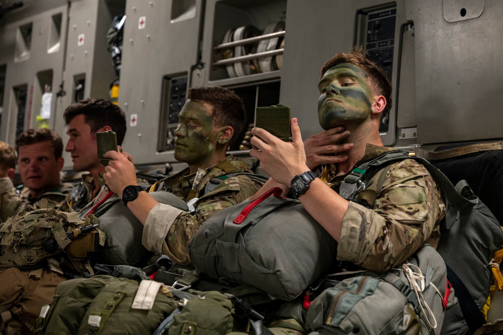 Army soldiers apply face paint