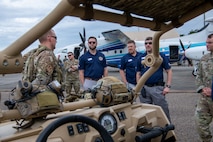 Civic leaders view an all-terrain vehicle.