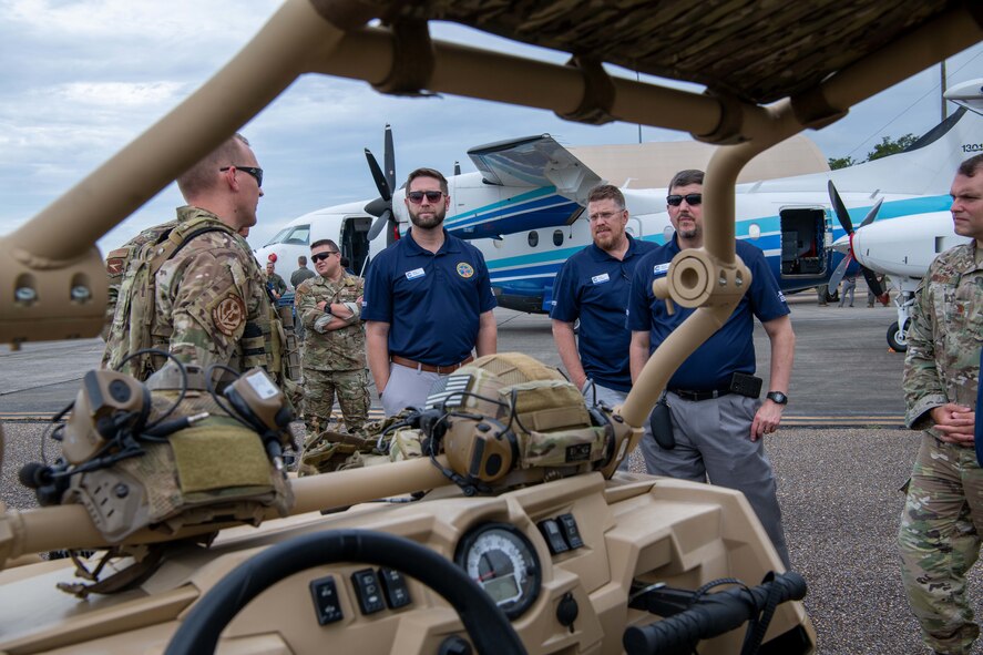 Civic leaders view an all-terrain vehicle.