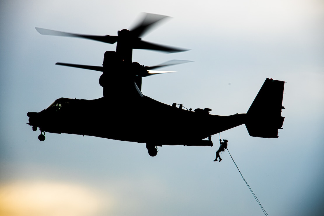 A U.S. Marine with 2d Reconnaissance Battalion attached to Task Force 61/2 rappels from a CV-22 Osprey during helicopter rope suspension techniques training with U.S. airmen from 7th Special Operations Squadron near Mildenhall, England, United Kingdom, June 16, 2022. Task Force 61/2 is executing the Commandant of the Marine Corps’ Concept for Stand-in Forces (SIF) to generate small, highly versatile units that integrate Marine Corps and Navy forces. Task Force 61/2 is deployed in the U.S. Naval Forces Europe area of operations, employed by U.S. Sixth Fleet to defend U.S., Allied and Partner interests. (U.S. Marine Corps photo by Sgt. Dylan Chagnon)