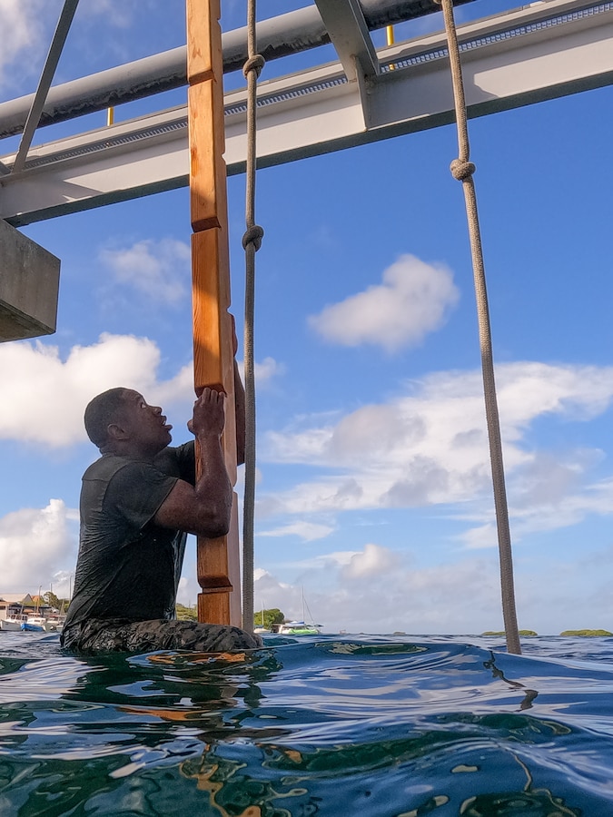 U.S. Marine Corps Cpl. Tyler Brewington, a reconnaissance Marine with 2d Reconnaissance Battalion, 2d Marine Division, navigates an obstacle course during Exercise Caribbean Coastal Warrior in Savaneta, Aruba, June 16, 2022.