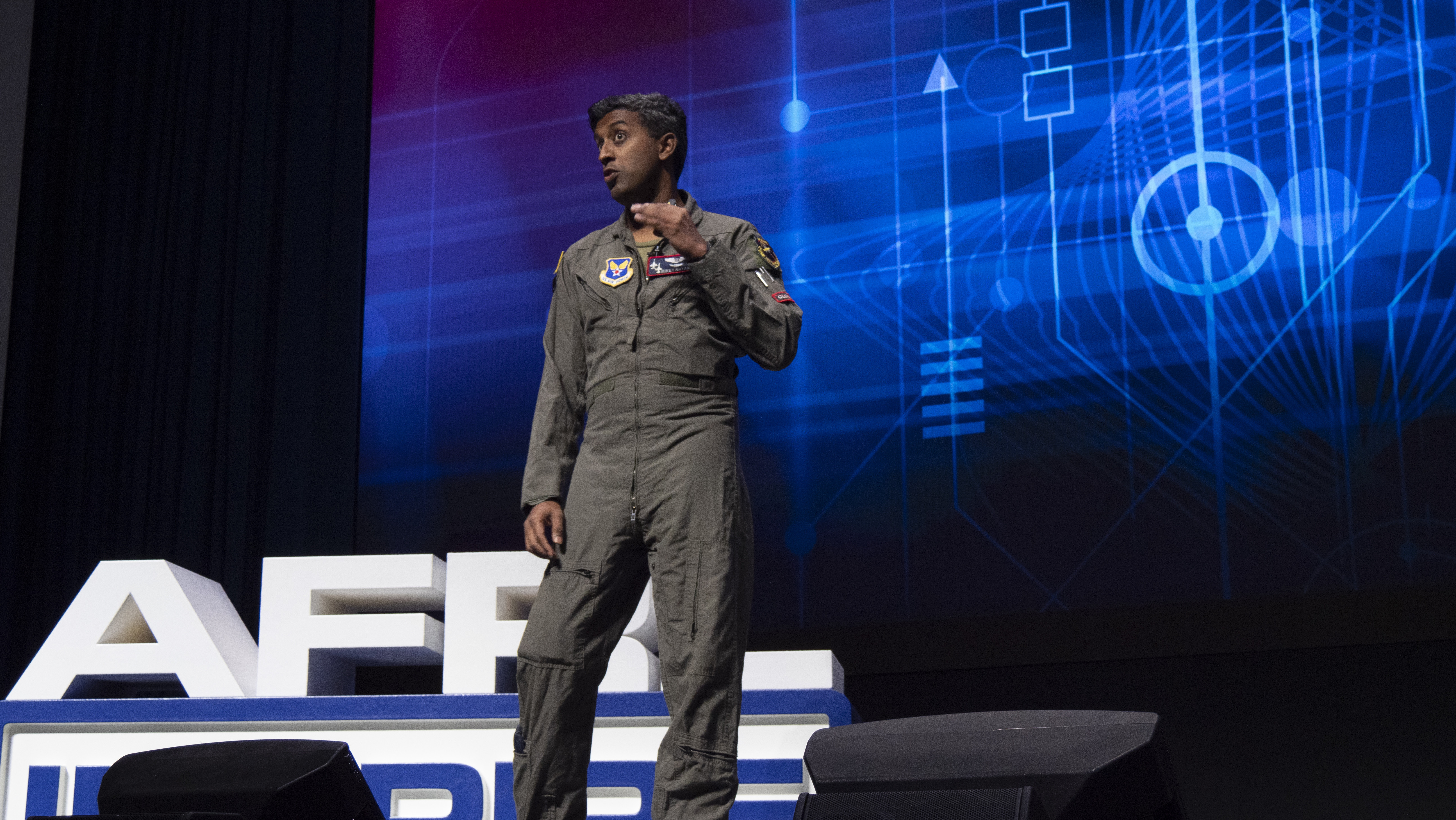 Maj. Michael Nayak, a planetary scientist and Defense Advanced Research Projects Agency program manager; formerly with the Air Force Research Laboratory’s Directed Energy Directorate, presents his talk titled, “Around the World in 80 Steps,” during AFRL Inspire. AFRL hosted this special TEDx-style event at the Air Force Institute of Technology's Kenney Hall at Wright-Patterson Air Force Base, Aug. 23, 2022. (U.S. Air Force photo / Keith Lewis)