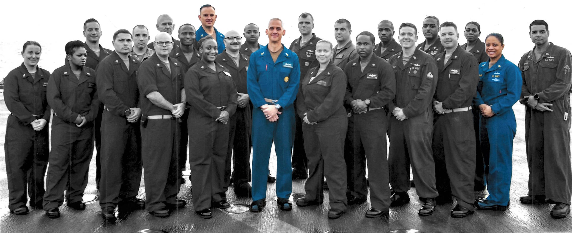 A group photograph of the USS Carter Hall chiefs mess. The individuals in color left to right are Senior Chief Brandon Majors, Master Chief Adam Singleton and Senior Chief Ioana Wolfinger.