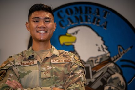 U.S. Air Force Airman 1st Class Jacob Cabanero, 1st Combat Camera Squadron public affairs specialist, poses for a photo in the squadron’s heritage room on Joint Base Charleston, South Carolina, August 19, 2022. Combat Camera acquires still and motion imagery in support of classified and unclassified air, sea, and ground military operations. (U.S. Air Force photo by Airman 1st Class Christian Silvera)