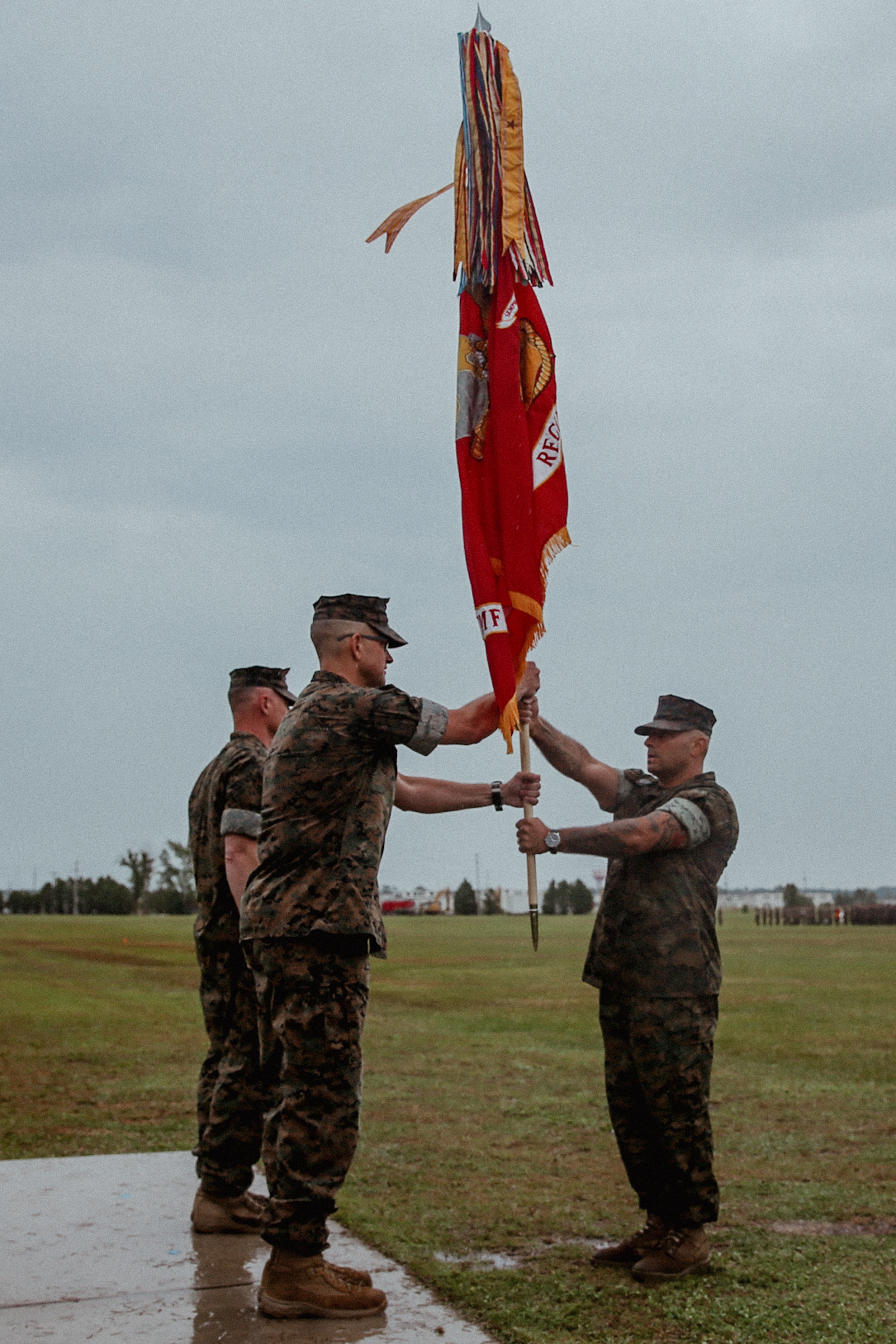 U.S. Marine Corps Col. Jeffery R. Kenney, left, the outgoing commanding officer of 6th Marine Regiment, 2d Marine Division, receives the regimental colors from Sgt. Maj. Giovanni A. Lobo, the regimental sergeant major, during a change of command ceremony on Camp Lejeune, North Carolina, June 29, 2022.
