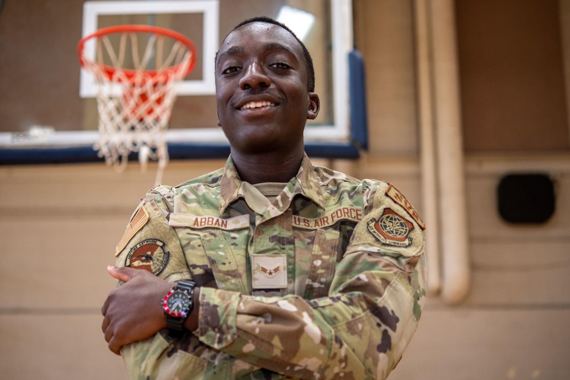 Airman 1st Class Christof Abban, 628th Force Support Squadron services specialist, poses for a photo on the basketball court at the Air Base Fitness and Sports Center on Joint Base Charleston, South Carolina, August 19, 2022. The squadron deploys worldwide to support military operations and provides support to more than 80,000 active duty personnel and their families, as well as retirees, DoD civilians, and reservists. (U.S. Air Force photo by Airman 1st Class Christian Silvera)