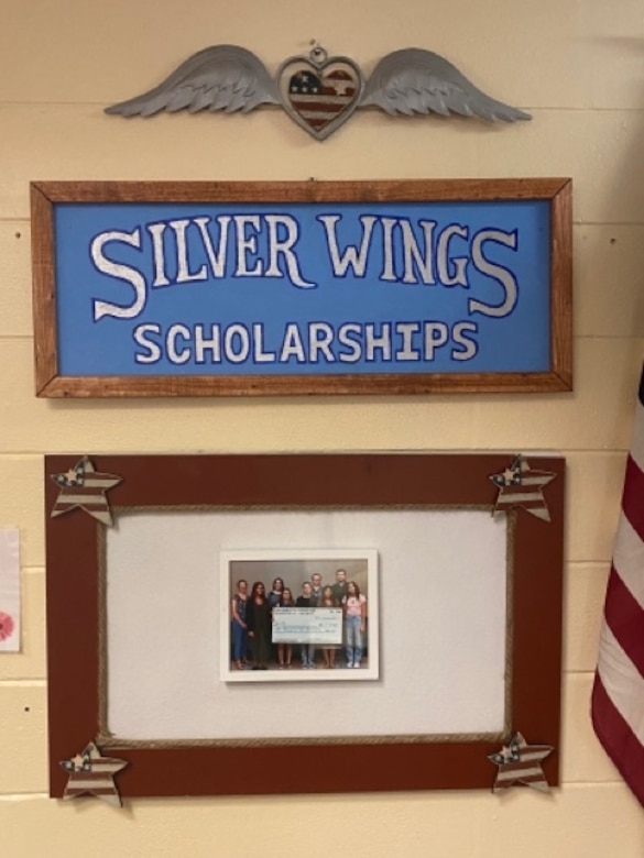 Team Charleston Spouses Thrift Store commemorates the recipients of the Silver Wings Scholarship Fund at Joint Base Charleston, South Carolina, July 5, 2022.