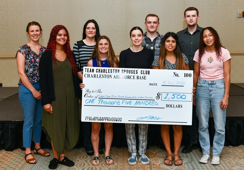 Recipients of the Silver Wings Scholarship Fund showcase the check they received at Joint Base Charleston, South Carolina, July 5, 2022.