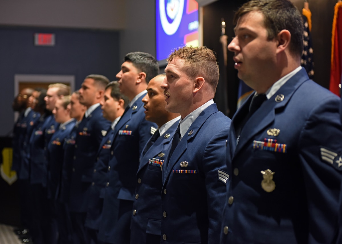 Airman Leadership School Class 22-F sings the Air Force song during the ALS graduation at the Powell Event Center, Goodfellow Air Force Base, Texas, Aug. 26, 2022. ALS is a five-week course designed to prepare senior airmen to assume supervisory duties through instruction in leadership, followership, written and oral communication skills, and the profession of arms. (U.S. Air Force photo by Airman 1st Class Sarah Williams)
