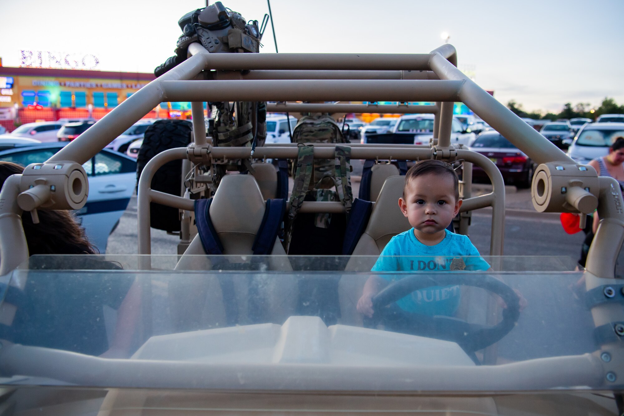 Axel, 1, explores a U.S. Air Force MRZR all-terrain vehicle during National Night Out Aug. 2, 2022, at Green Acres Park, Clovis, New Mexico. Air Commandos from the 27th Special Operations Wing, 27th Special Operations Security Forces Squadron, Cannon Air Force Base, and various New Mexico law enforcement and first responders took part in the event, which is part of a nation-wide campaign to strengthen community safety and enhance relationships between residents and law enforcement. (U.S. Air Force photo by Staff Sgt. Peter Reft)