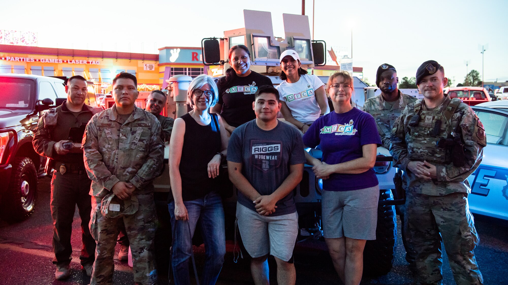 U.S. Airmen, New Mexico State Police, and Clovis community members gather for a group photo during National Night Out Aug. 2, 2022, at Green Acres Park, Clovis, New Mexico. Air Commandos from the 27th Special Operations Wing, 27th Special Operations Security Forces Squadron, Cannon Air Force Base, and various New Mexico law enforcement and first responders took part in the event, which is part of a nation-wide campaign to strengthen community safety and enhance relationships between residents and law enforcement. (U.S. Air Force photo by Staff Sgt. Peter Reft)