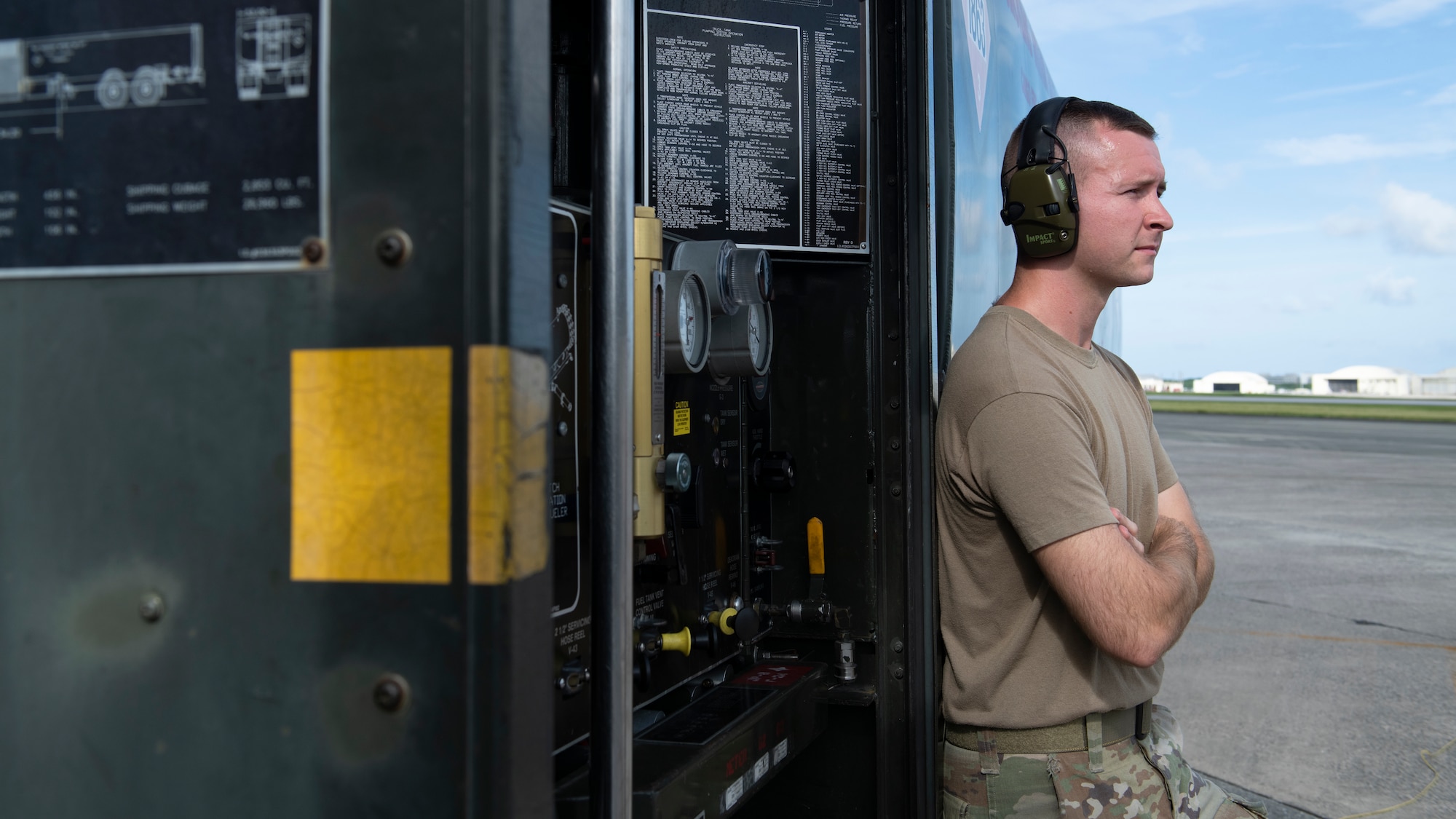 An Airman assigned to the 18th Logistics Readiness Squadron petroleum, oils and lubricants flight monitors hot-pit refueling during surge operations at Kadena Air Base, Japan, Aug. 24, 2022. During a hot-pit refuel, the pilot remains in the cockpit with engines running while maintenance crews perform safety checks and refuel the aircraft, cutting the time between sorties to less than 30 minutes. (U.S. Air Force photo by Senior Airman Jessi Roth)