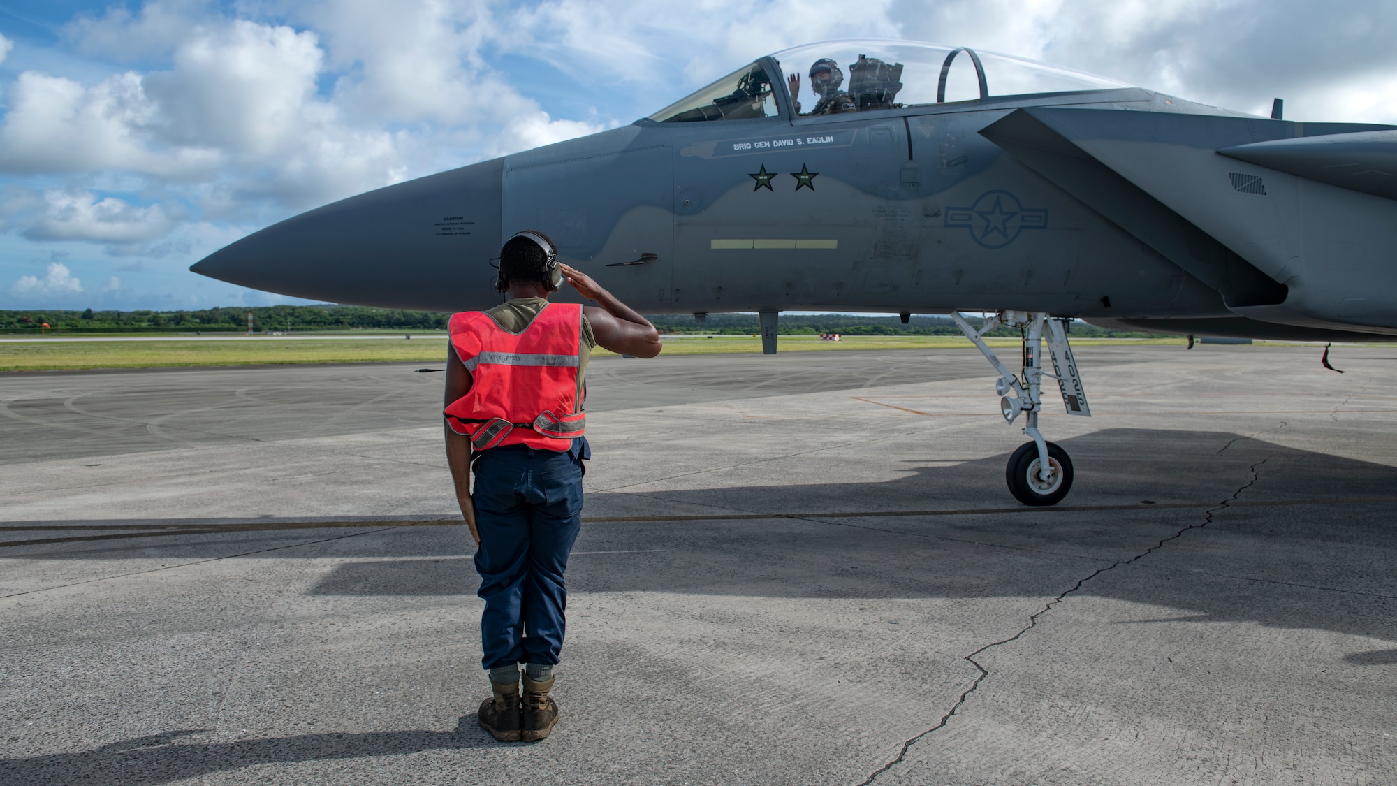 A crew chief assigned to the 44th Aircraft Maintenance Unit salutes the pilot as he departs the service apron during surge operations at Kadena Air Base, Japan, Aug. 24, 2022. Surge operations are a vital component to the development of aircrew and support personnel, allowing them to build and further improve the skills needed to remain a ready and capable force. (U.S. Air Force photo by Senior Airman Jessi Roth)