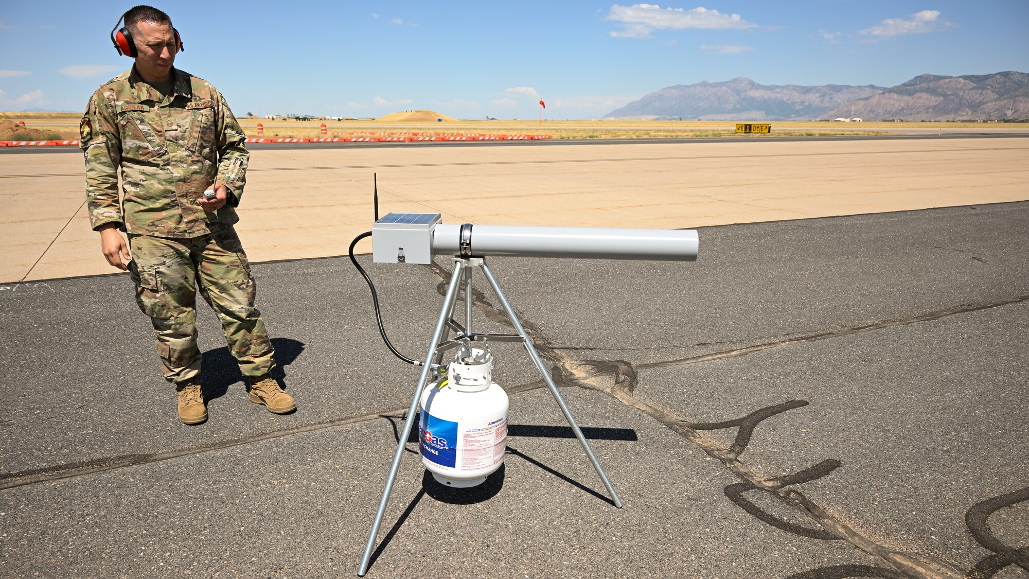 Master Sgt. Chris Aguilar, 75th Air Base Wing Safety Office superintendent, fires a propane cannon.