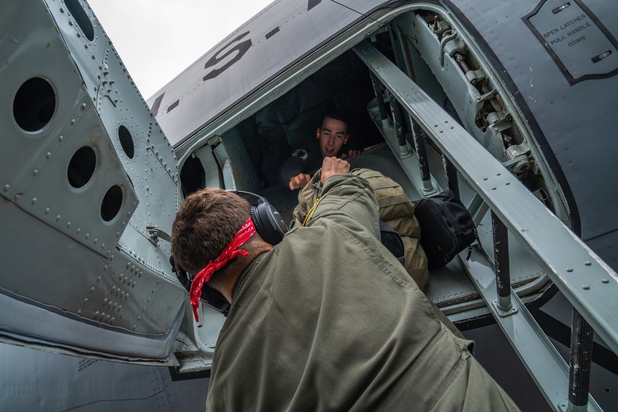 U.S. Air Force Staff Sgt. Dalton Degeneffe, 50th Air Refueling Squadron boom operator, hands luggage to Capt. Andrew Bragado, 50th ARS pilot, prior to a flight during the 6th Air Refueling Wing’s Agile Combat Employment capstone exercise at Joint Base Charleston, South Carolina, Aug. 23, 2022.