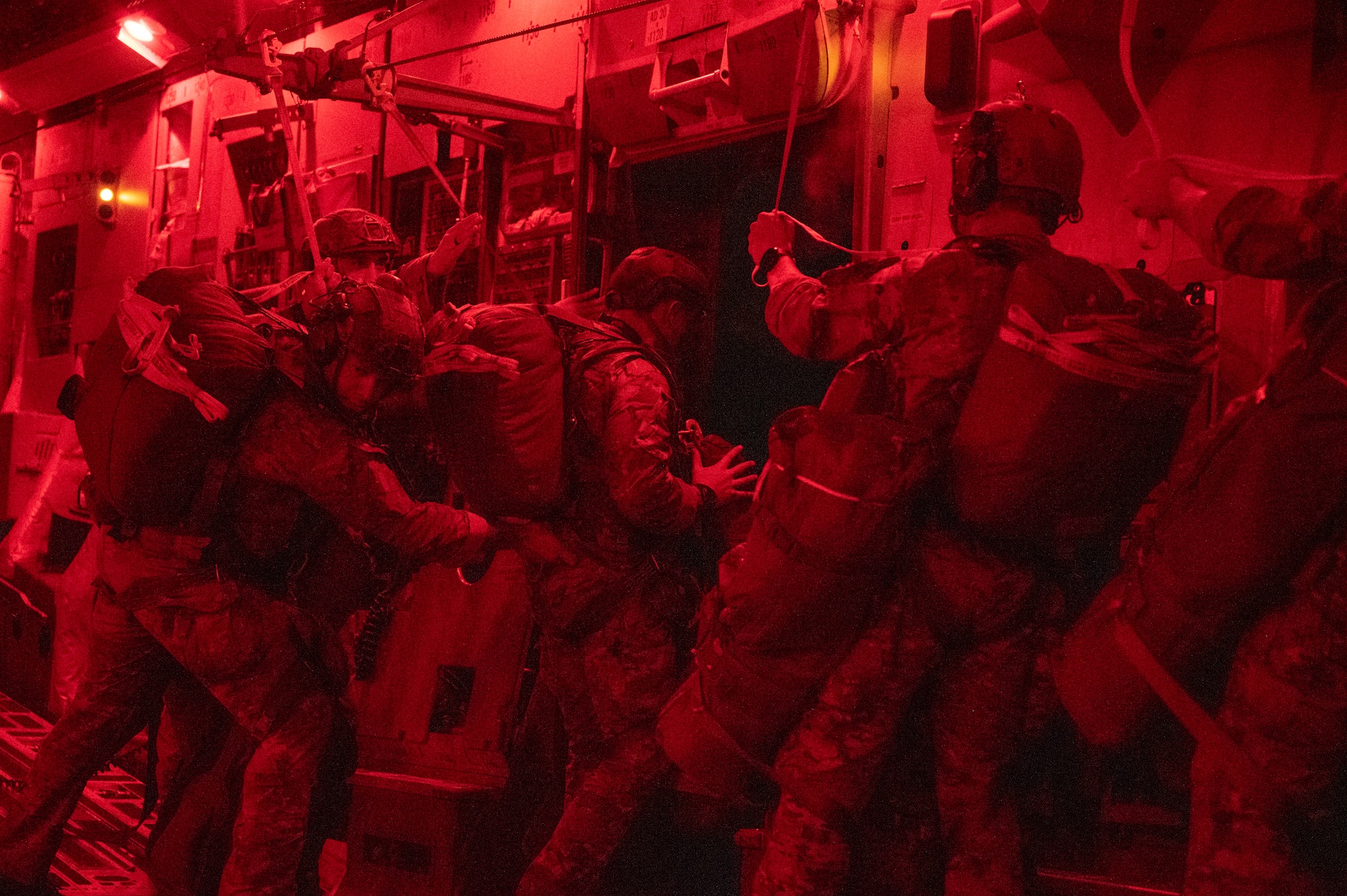 Army rangers prepare to jump out of a C-17.